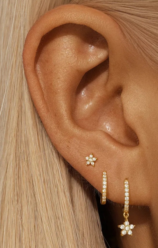 925 Sterling Silver Gold Plated Flower Star Earrings Set with Zirconia worn on model ear